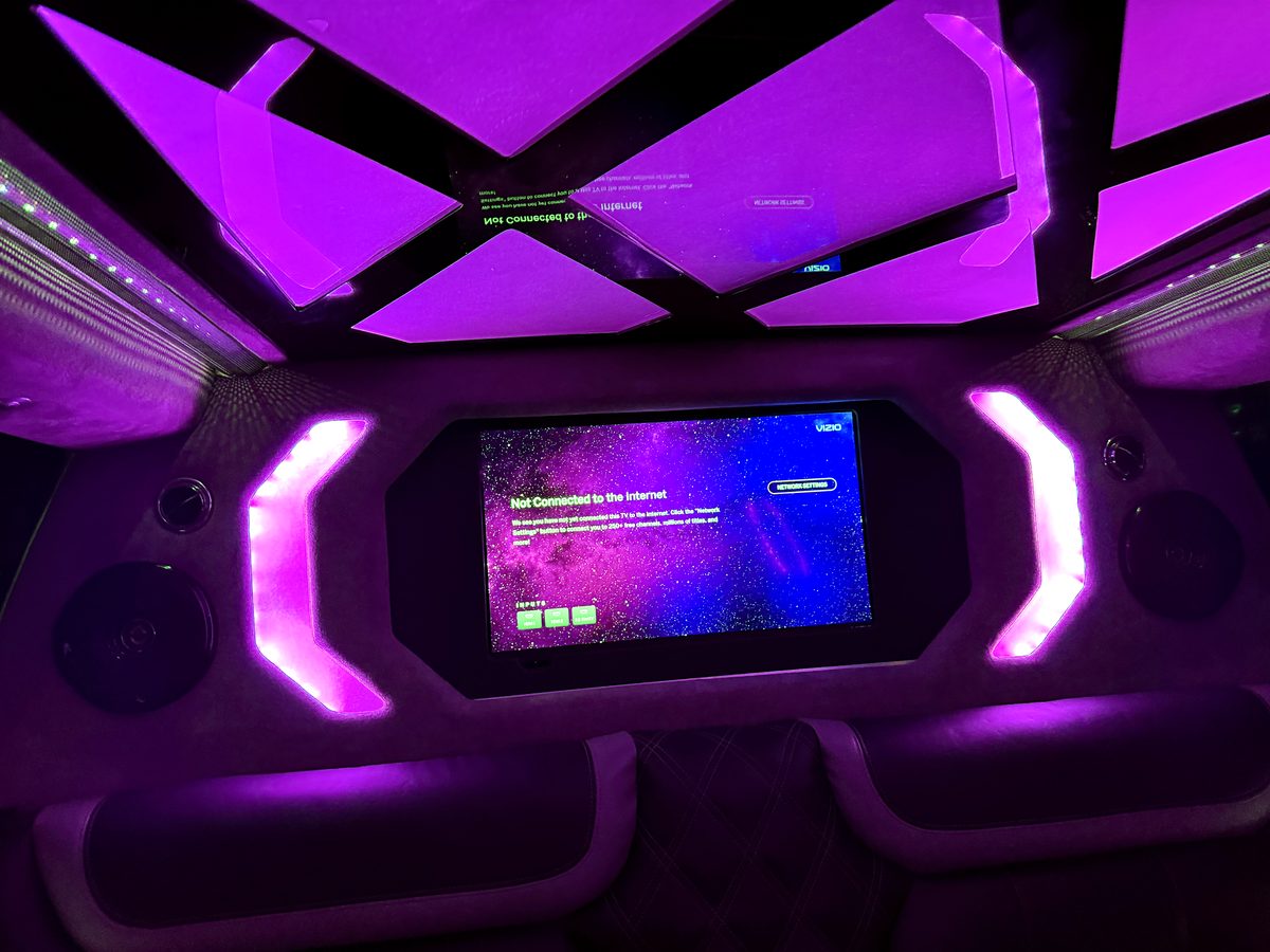 2024 Escalade screen with Apple TV under purple ceiling