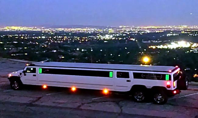 Six-wheel Hummer overlooking city lights