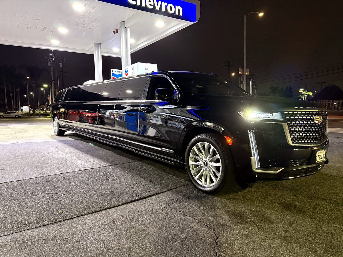 Escalade super stretch limousine at night before an LAFC match